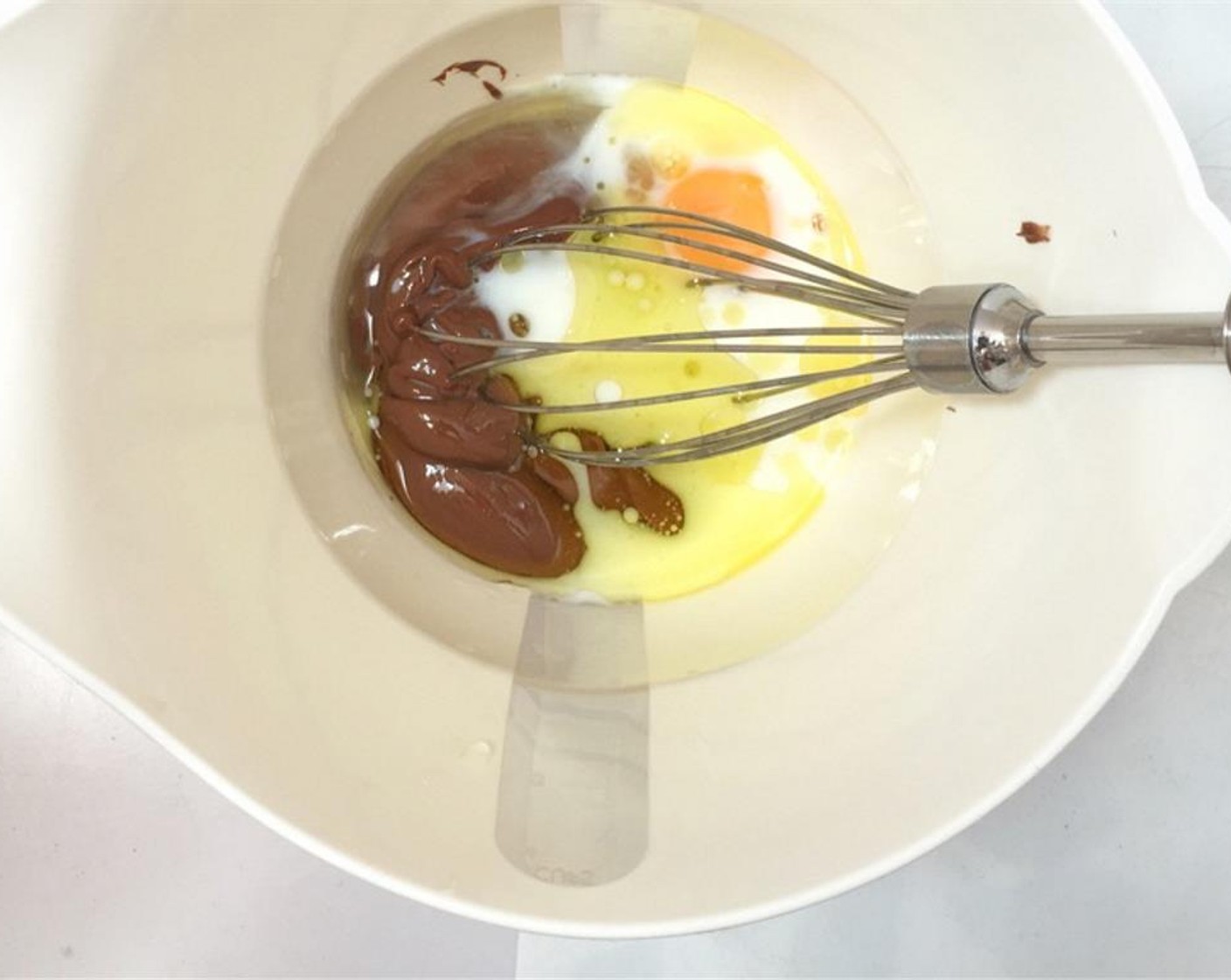 step 1 Add the Milk (3 Tbsp), Egg (1), Vegetable Oil (2 Tbsp) and Nutella® (3 Tbsp) to a high measuring cup.