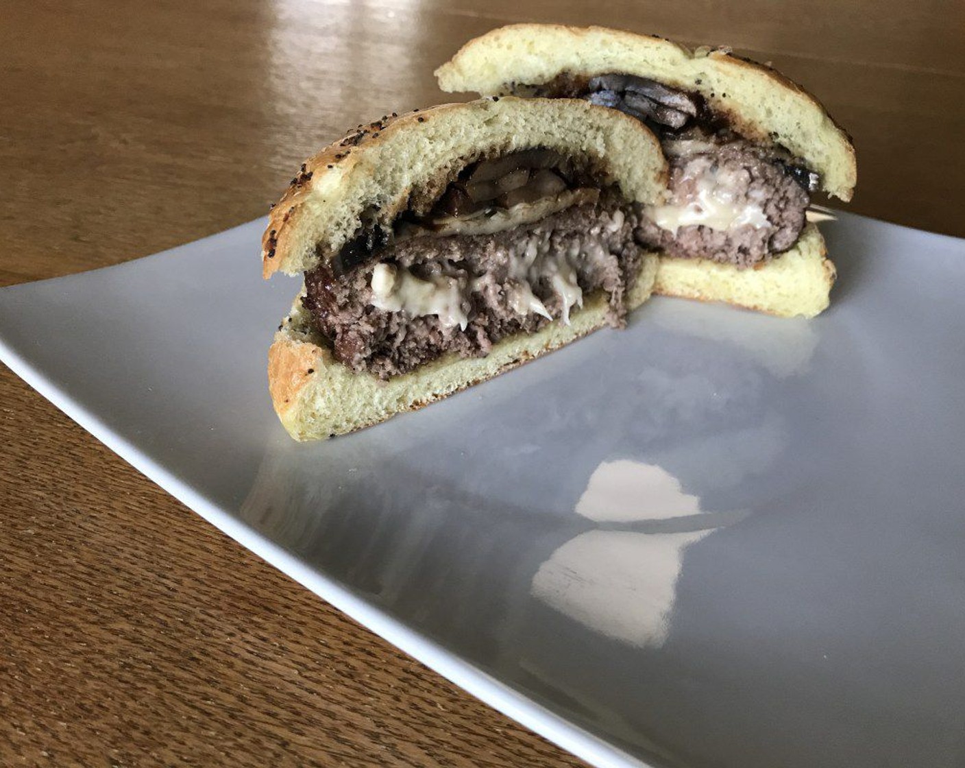 step 8 Make sure burgers have been cooling for at least 10 minutes so the cheese filling isn't boiling hot. Slice burgers in half if desired, or just serve whole for guest to bite into the cheesy surprise.