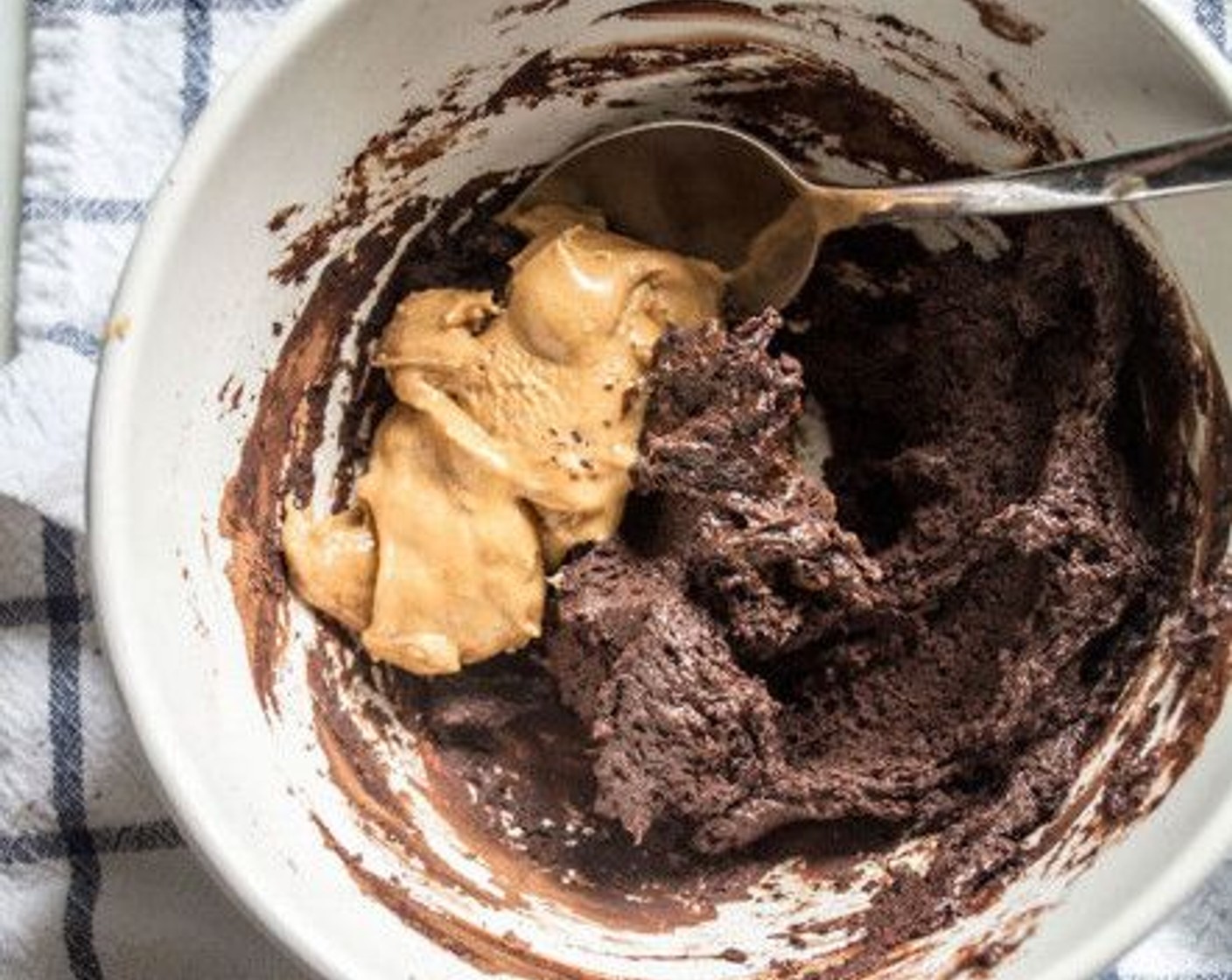 step 5 For the filling, add the Cacao Nibs (1/2 cup) or powder to a small bowl, followed by the remaining Unrefined Coconut Oil (1 Tbsp), Raw Honey (1 Tbsp), Maple Syrup (1 Tbsp) and Pure Vanilla Extract (1/2 tsp). Stir to combine, then add in Peanut Butter (1/2 cup) and continue stirring until a thick, smooth consistency is reached.