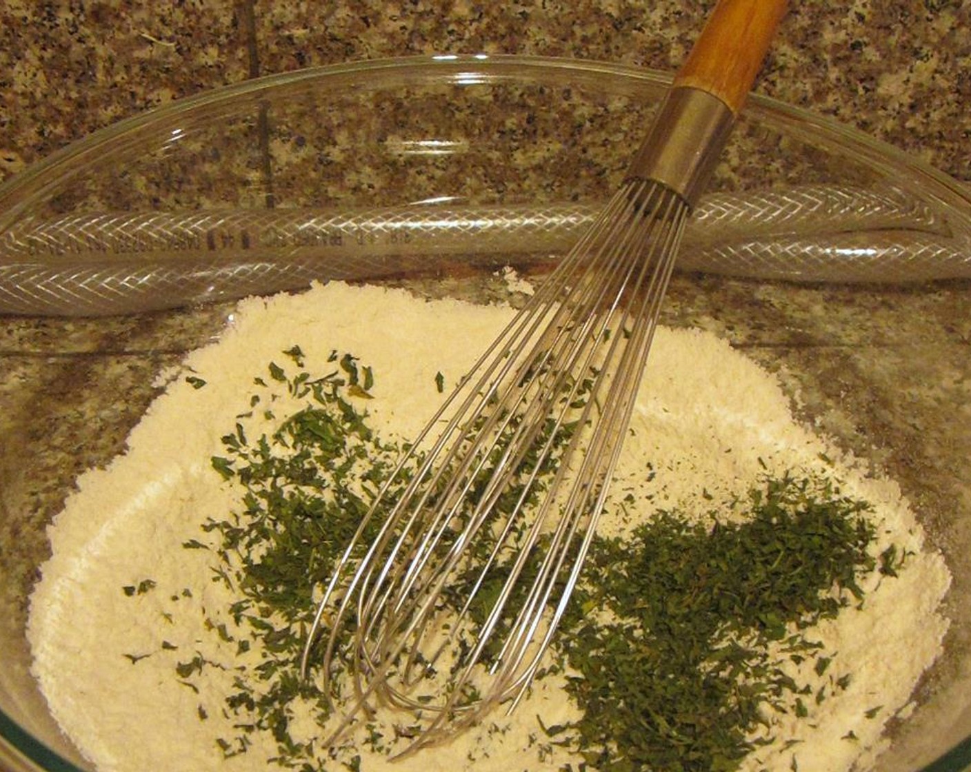 step 5 While your chicken is cooking, make your dumplings. In a medium-sized mixing bowl, whisk together All-Purpose Flour (1/3 cup), Baking Powder (1 tsp), and Salt (1 tsp). Once combined, add chopped fresh Italian Flat-Leaf Parsley (2 Tbsp) and mix again.