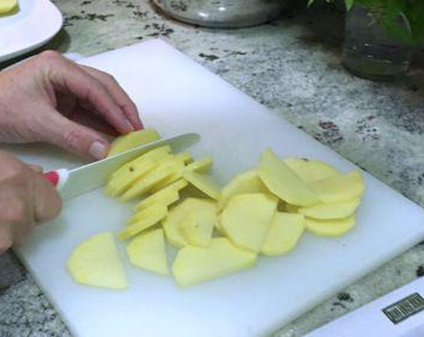 step 2 Peel the Yukon Gold Potatoes (4) then cut them in half, and slice into 1/8 to 1/4 inch slices.