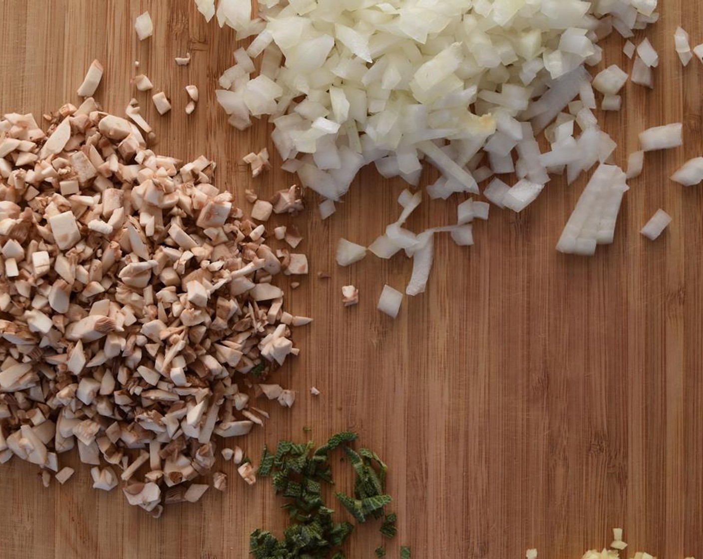 step 3 Finely chop 3 of the mushrooms and set the others aside. Finely dice the Onion (1/2), mince the Garlic (1 clove) and chop the Sage Leaves (3). Set aside.