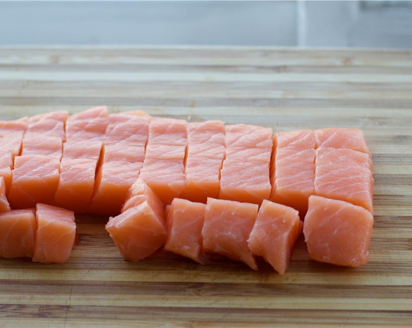 step 3 Gently dry the Sushi Grade Salmon (1 lb) with paper towels. Carefully cut into half-inch cubes and place in the bowl with the sauce.