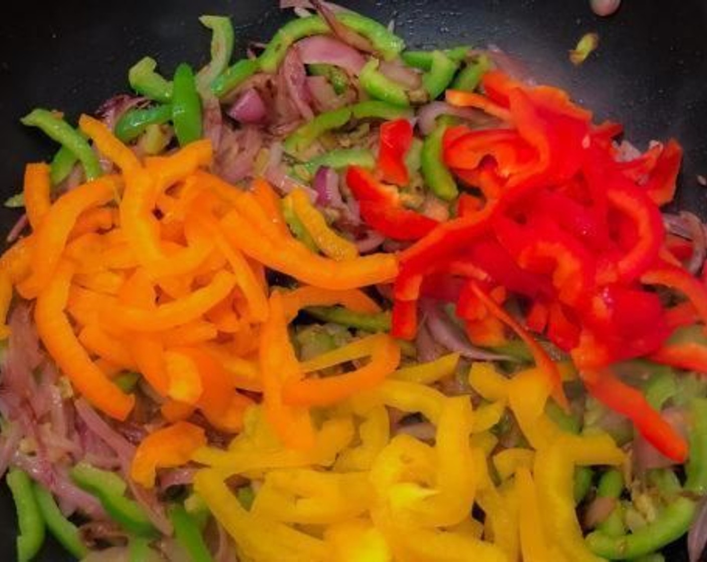 step 3 After that add slices of Onion (1/2), sauté it. Don't let it cook too much maintain the crunchiness of vegetables. Add Green Chili Peppers (3) and Assorted Color Bell Peppers (2), you can use whatever color peppers you have in hand. Sauté all of them on high maintaining the crunchiness.