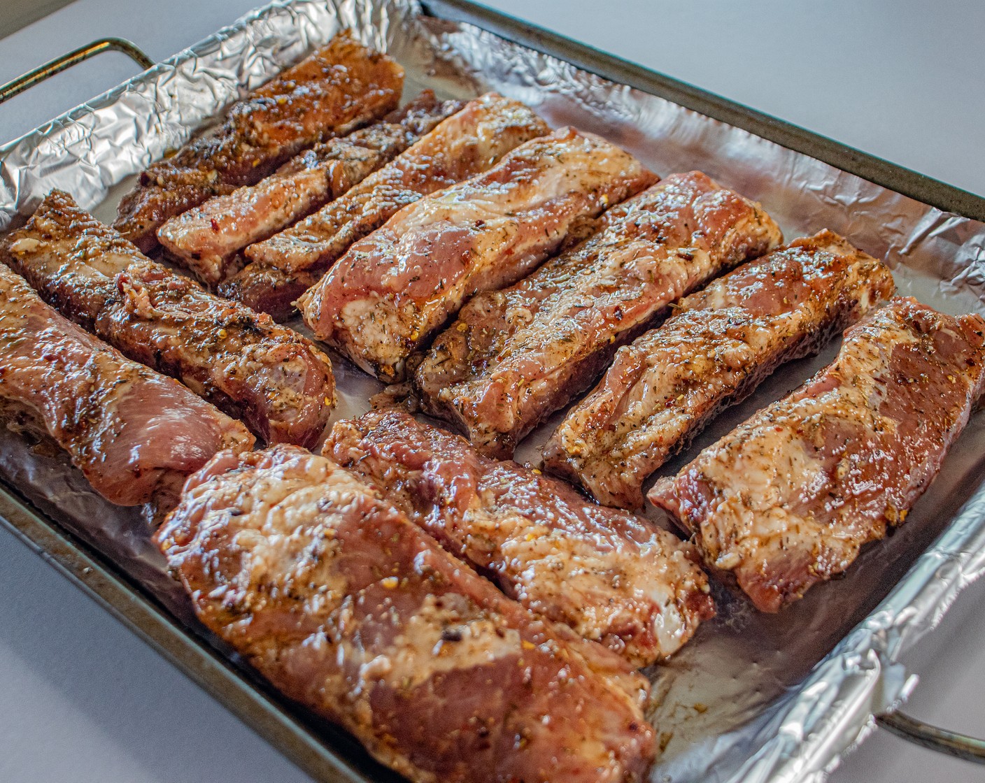 step 5 On a nonstick aluminum lined baking sheet, place the ribs bone side down. Cover with aluminum foil.
