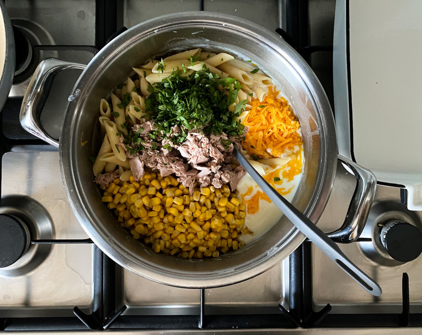 step 5 Add Canned Tuna in Water (1 cup), Sweet Corn Kernels (1 can), 3/4 of the cheese, and Italian Flat-Leaf Parsley (1 handful). Mix until evenly combined. Season well with Salt (to taste) and Freshly Ground Black Pepper (to taste).