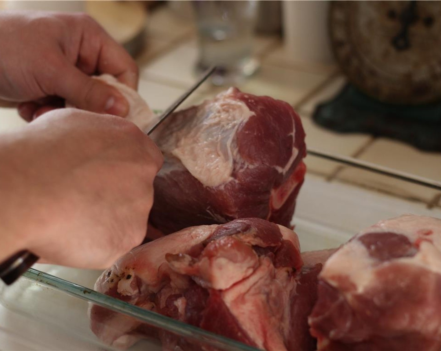 step 5 With a paper towel, pat the Bone-in Pork Shoulder (4 lb) dry, and begin trimming away any excess fat.