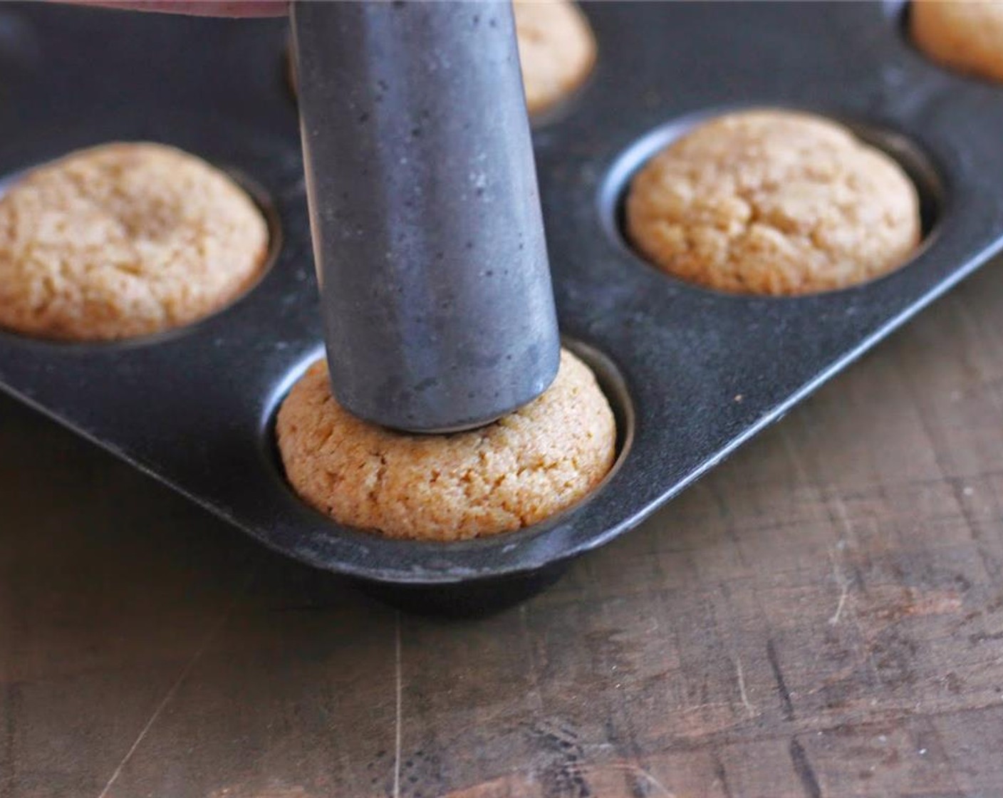 step 5 Using the rounded end of the handle of a cooking tool, such as a ice cream scoop or large wooden spoon, press into each baked cookie while still in the pan to form a tart. Allow to cool and remove from pan.