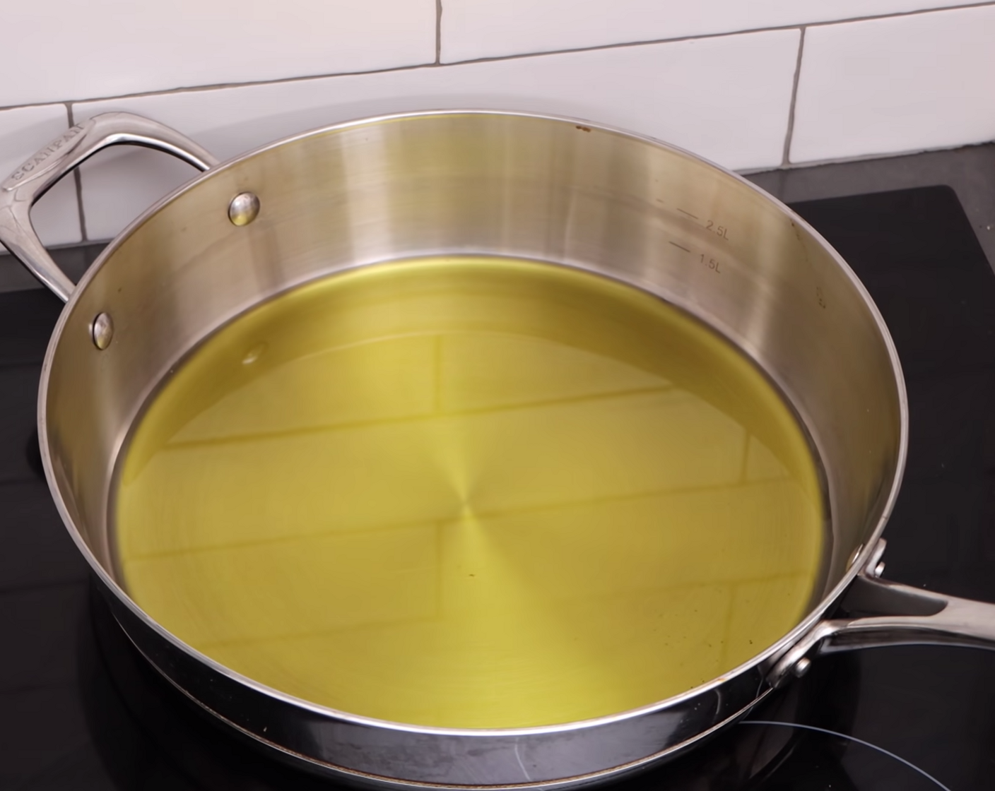 step 4 Place your frying pan on the stove and turn it up to medium heat. Once it has started to warm add a generous amount of Extra-Virgin Olive Oil (1/3 cup), and the garlic, gently mixing it into the oil using a wooden spoon.