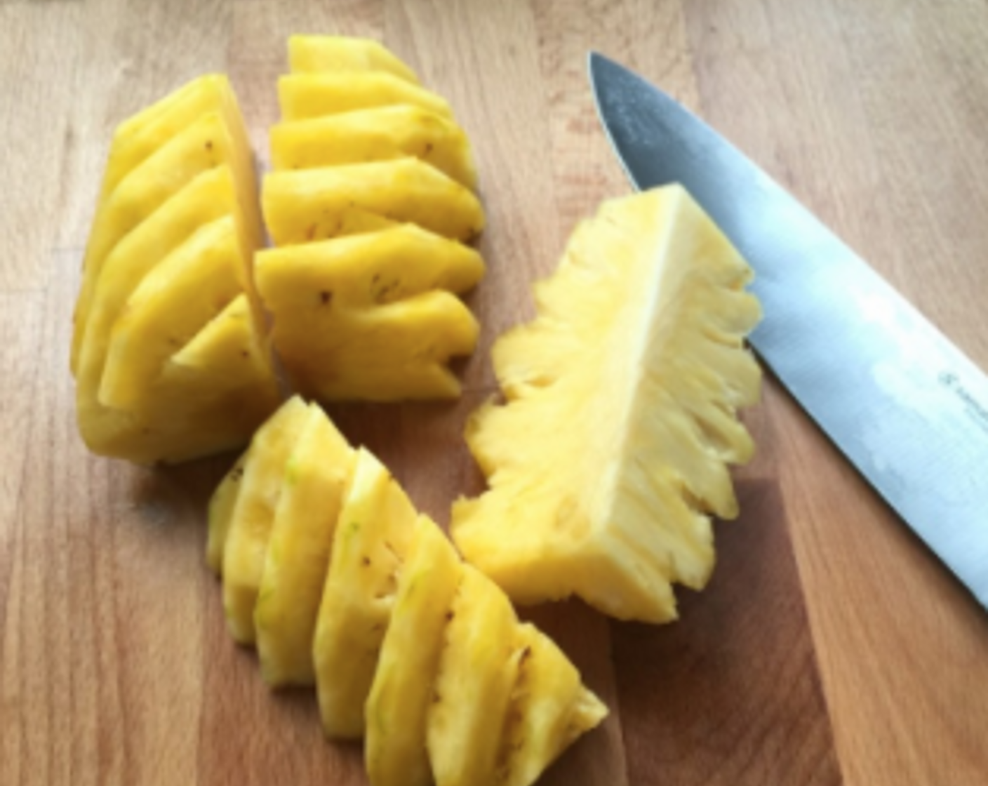 step 8 Next, slice the pineapple into long quarters. And we're ready to grate the sliced pineapples!