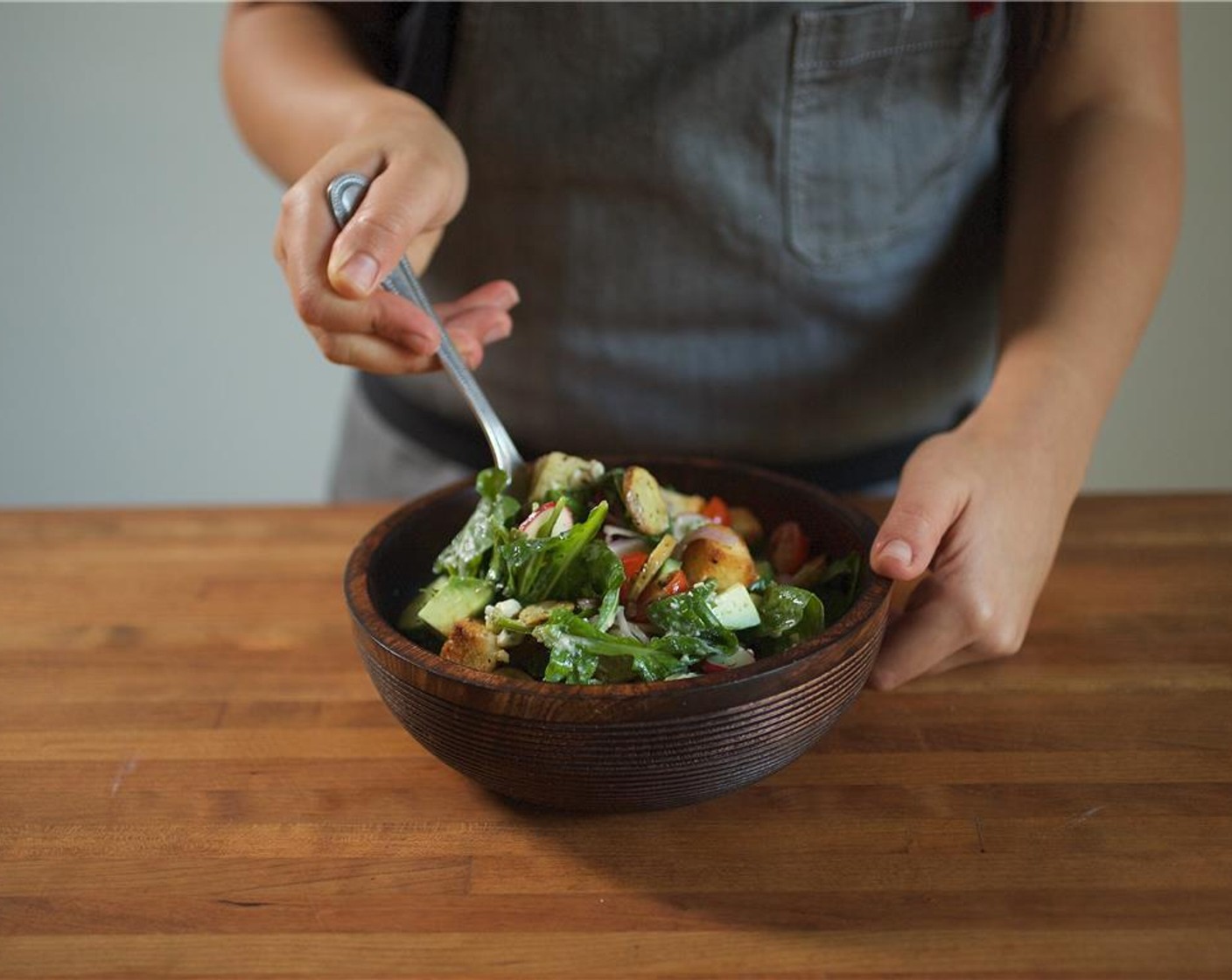 step 12 Gently toss the salad with 3/4 of the dressing, reserving the rest of the dressing for steak when plating. Slice each steak into 10 slices on a bias. If desired, you can trim the fat off the steak. Mound with height the salad divided between two plates.