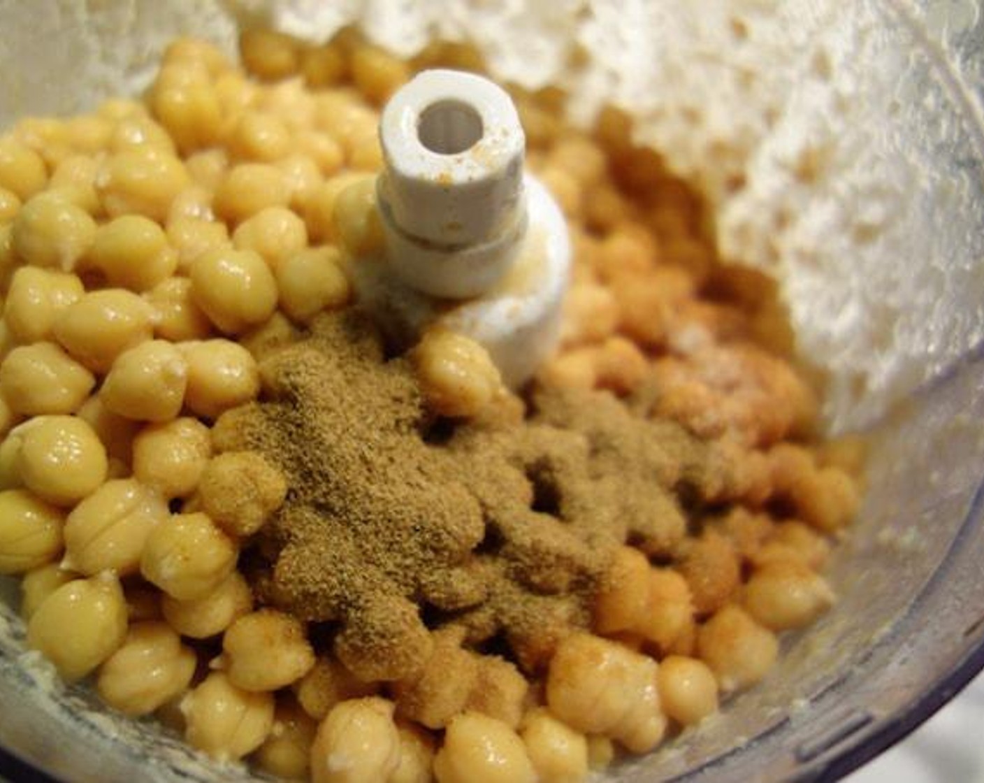 step 5 Put chickpeas, Ground Cumin (1 tsp), Ground Coriander (1 tsp), Cayenne Pepper (1/2 tsp) and Kosher Salt (1 tsp) all in the food processor.