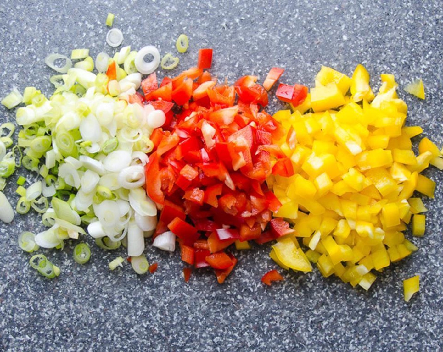 step 2 Dice the Red Bell Pepper (1/2), and the Yellow Bell Pepper (1/2) into 1/2-inch pieces. Thinly slice the Scallion (1 bunch).