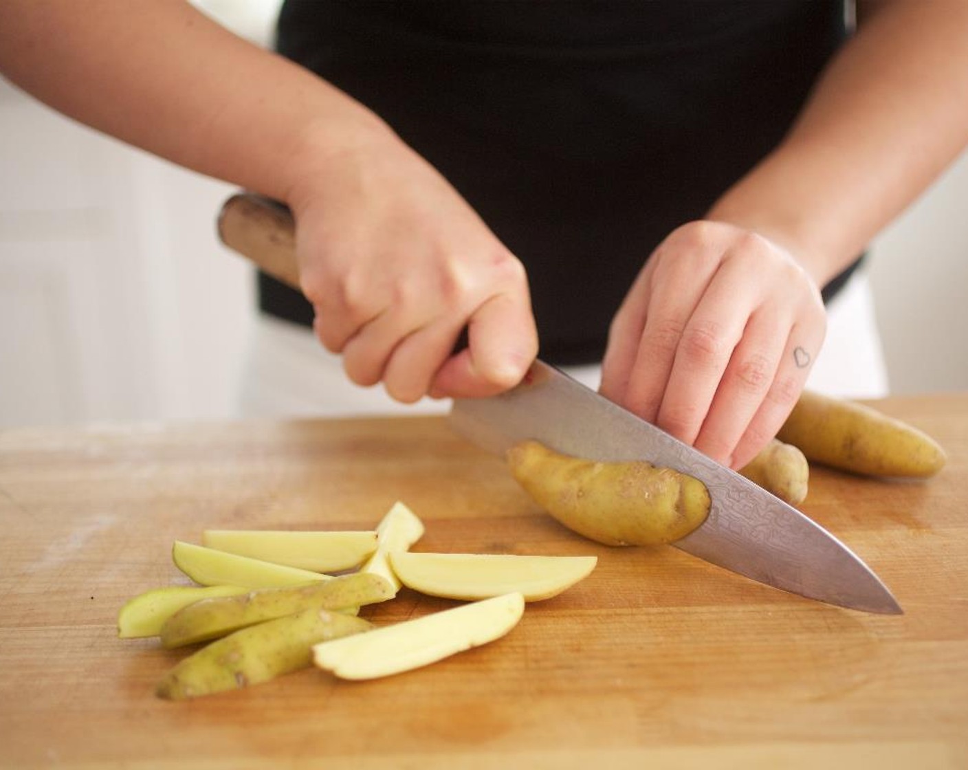 step 2 Cut the Fingerling Potatoes (1 1/2 cups) into quarters; place into a medium bowl. Toss with Olive Oil (1 tsp), Salt (1/4 tsp), and Ground Black Pepper (1/4 tsp).