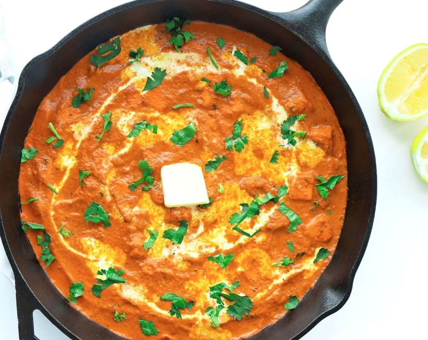 step 14 Pour the Kemps Half & Half (2 Tbsp) in a circular motion over the Paneer Butter Masala, sprinkle with Fresh Cilantro (1 Tbsp) and add a small dollop of Unsalted Butter (1 tsp) to the center of the dish.