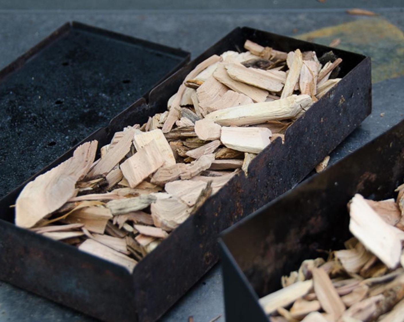 step 2 Prepare the grill or smoker for indirect cooking. Add the dry wood chips to the smoker box.  Set the wood chips over the heat source on the grill and heat until it reaches about 250 degrees F to 275 degrees F and begins to smoke.