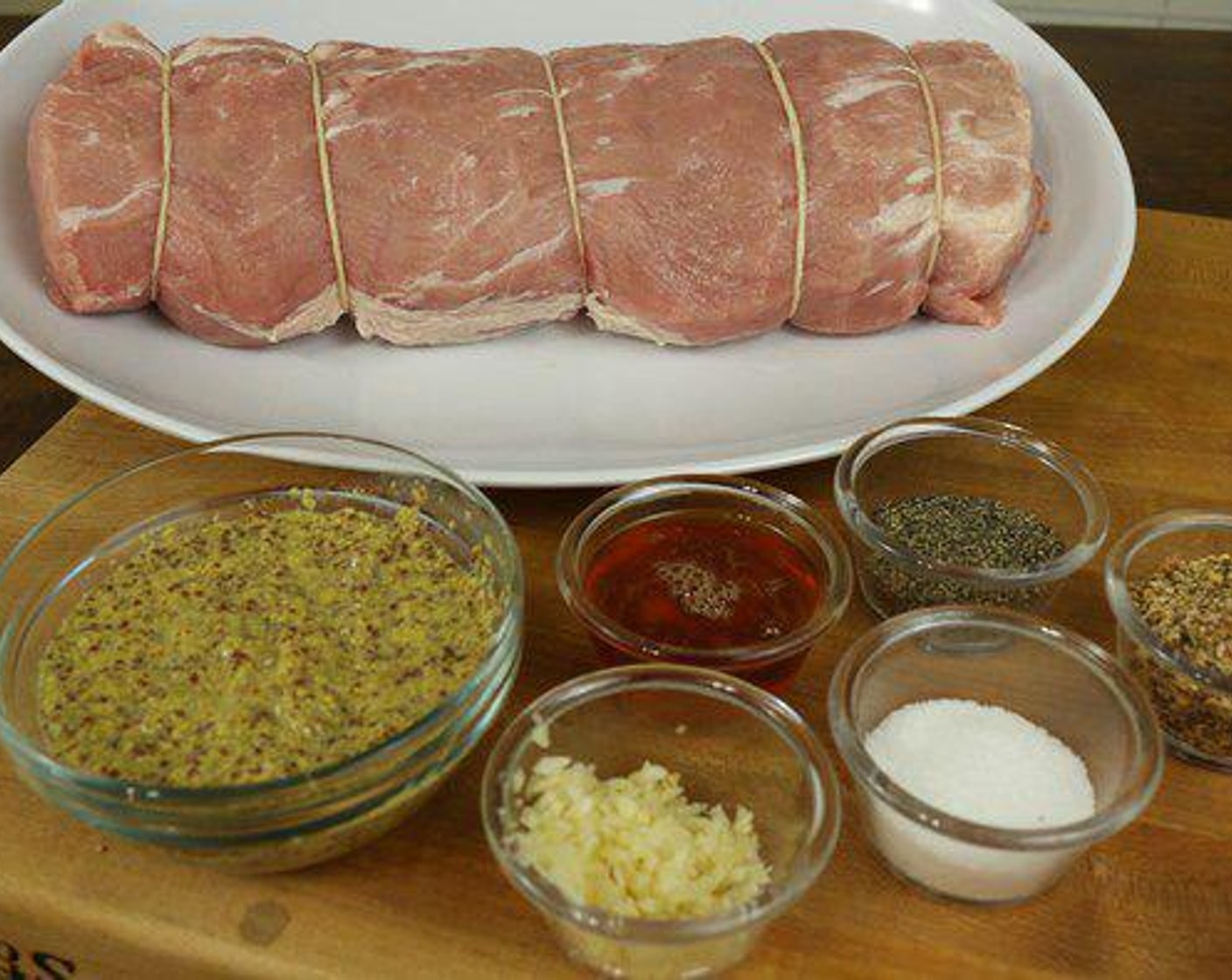 step 1 Take the Boneless Pork Loin (4 lb) and remove any heavy silver skin off the top. Then I used butcher twine to tie it up (it helps the pork loin hold its shape). It’s fairly simple, you just work down the pork loin tying knots. If you get your pork loin from a butcher, they can do this step for you.