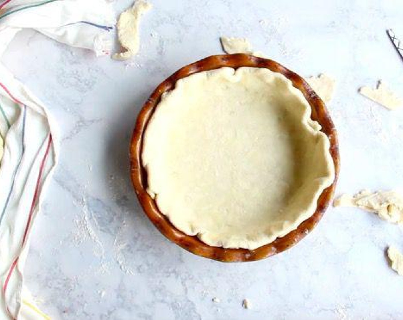 step 3 If baking one immediately, lightly flour a work surface, roll out into a circle an inch or two larger than your pie plate, transfer to pie plate, trim over hanging dough, then crimp dough as desired. Chill in fridge while you prepare the filling.