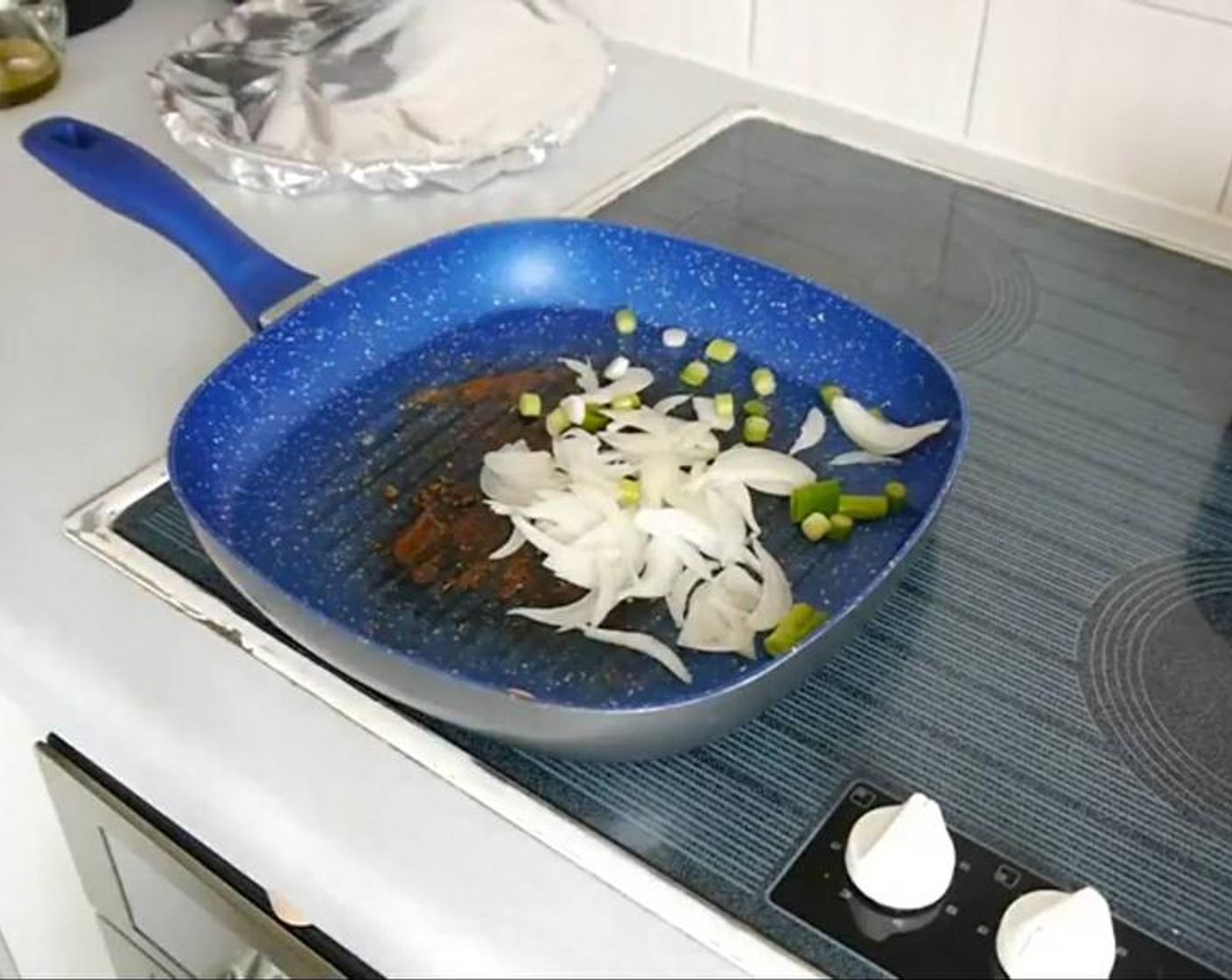 step 5 Once the steak is done, put it on a plate and cover it with aluminium foil so it rests. In the meantime to the same grill or skillet add the onions and Spring onions with some olive oil and a knob of Butter (to taste) and cook until the onions are brown.