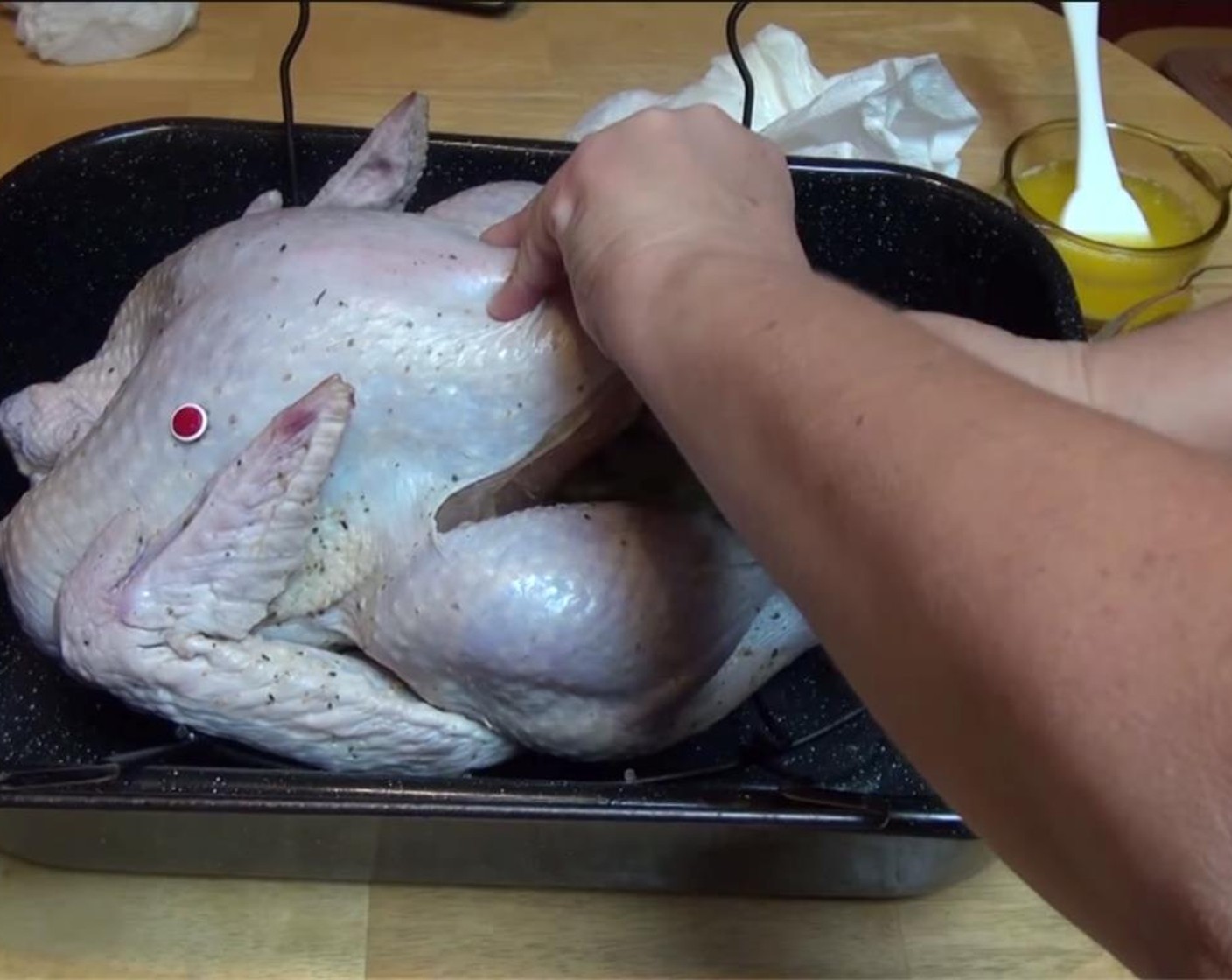 step 9 Place the Celery Leaves (2) tops, Fresh Sage (1 sprig), Fresh Rosemary (2 sprigs), Fresh Thyme (2 sprigs), Garlic (4 cloves), orange, apple and White Onion (1/2) inside the cavity of the turkey, and tie the legs together.