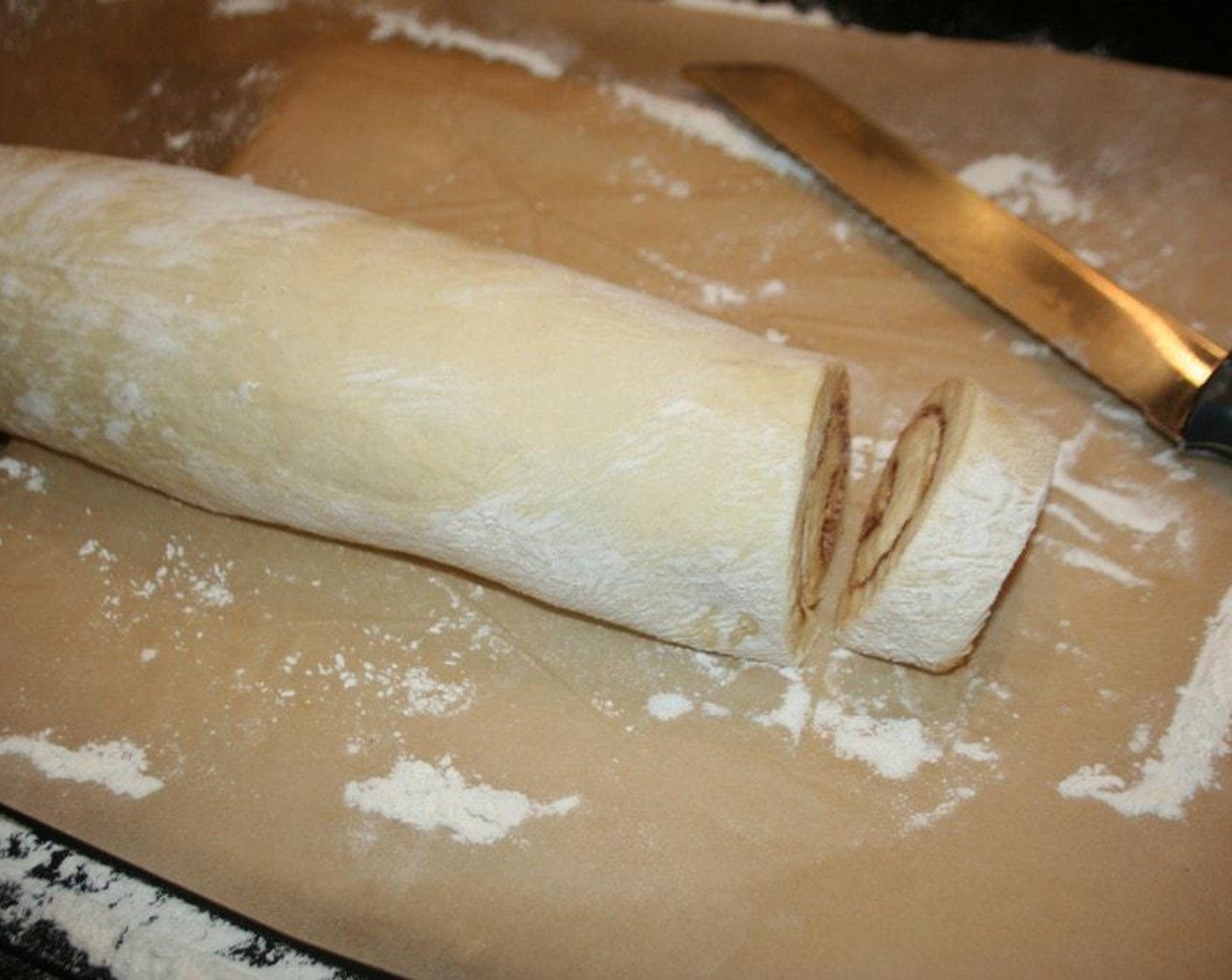 step 6 Roll up tightly then cut in one inch circles and place in a buttered baking dish. Use a 1/4 sheet pan lined with parchment paper, that has been buttered.