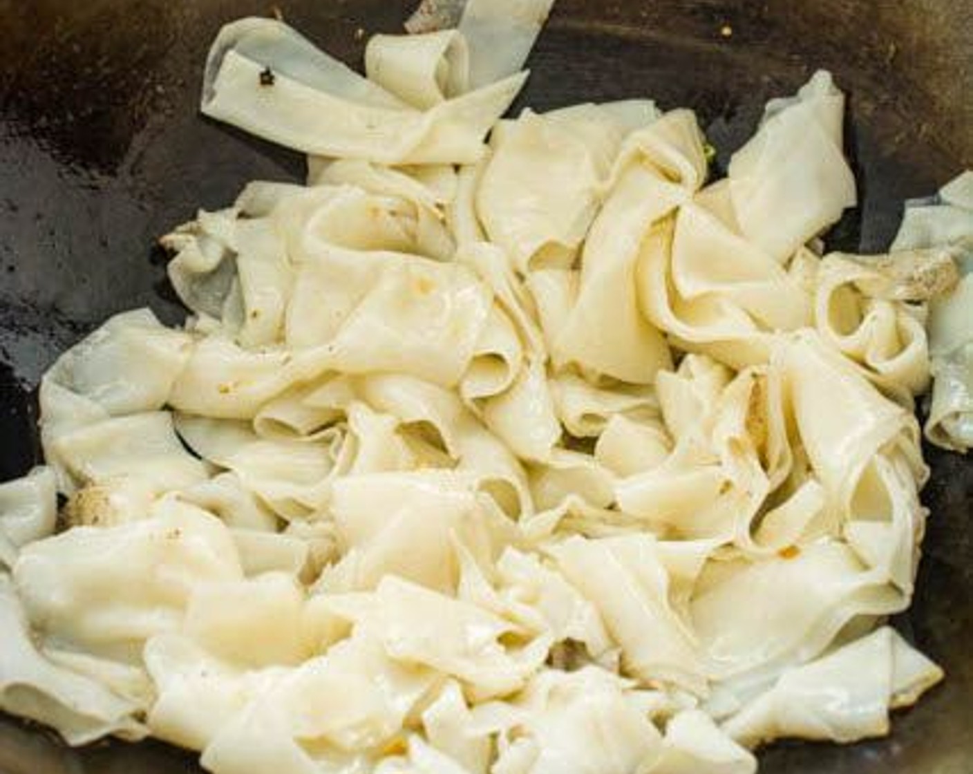 step 13 Add the rice noodles to the wok, spreading them out in a single layer.