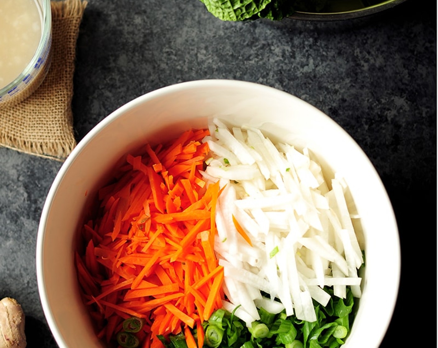 step 8 Now, prepare the vegetables. Peel the Daikon Radishes (2 cups) and Carrot (1 cup) and cut them into thin matchsticks. Set aside. Chop Scallions (10 stalks) and place them together with the daikon and carrots. Set aside.