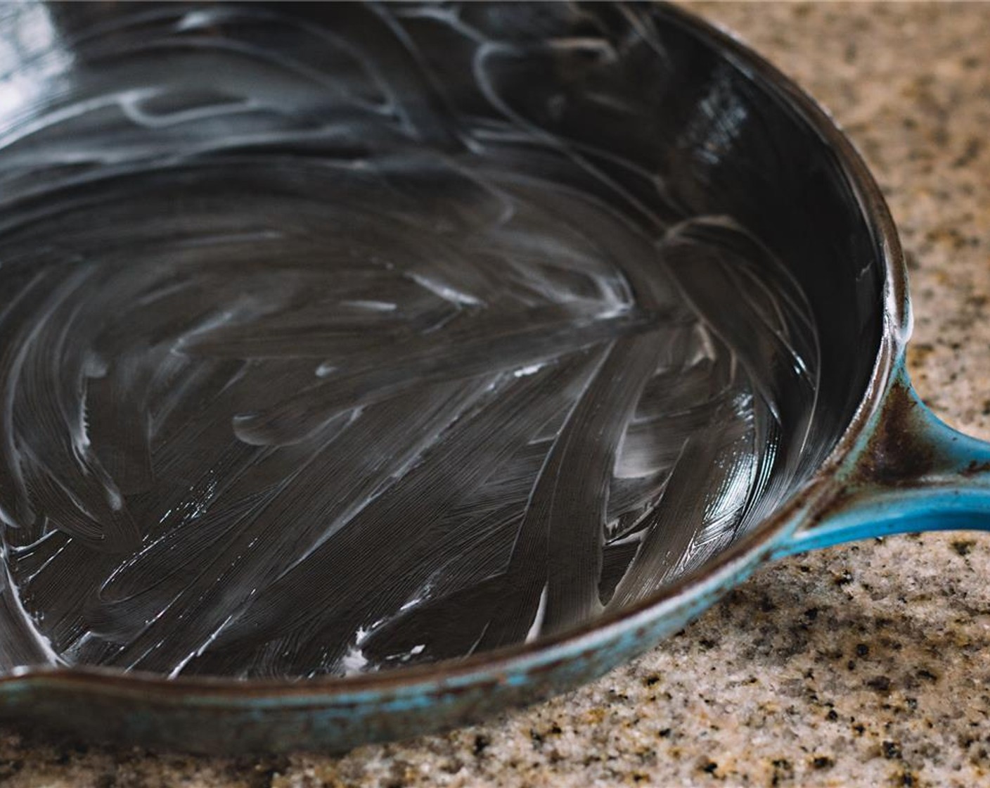 step 1 Preheat the oven to 375 degrees F (190 degrees C). Thoroughly grease an 11-inch cast iron skillet.