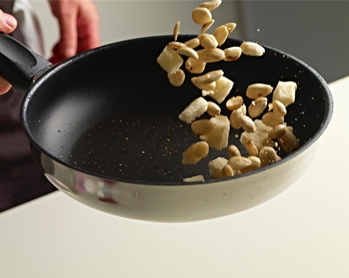 step 4 Cut the crust off the Bread (3 slices) and cut it into small cubes. Place crushed Garlic (2 cloves), bread cubes and half of Extra-Virgin Olive Oil (2 Tbsp) in a frying pan and toast it over a gentle heat.