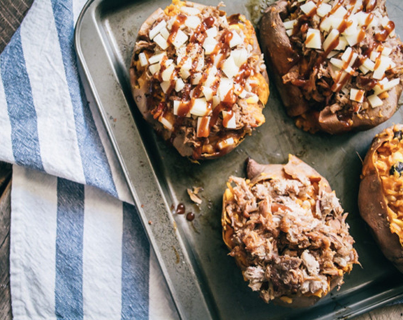 step 10 Scoop sweet potato filling into the skins, then top each with BBQ pulled pork and Muenster Cheese (3/4 cup). Drizzle with Barbecue Sauce (2 Tbsp) then bake another 6-7 minutes or until the cheese has melted.