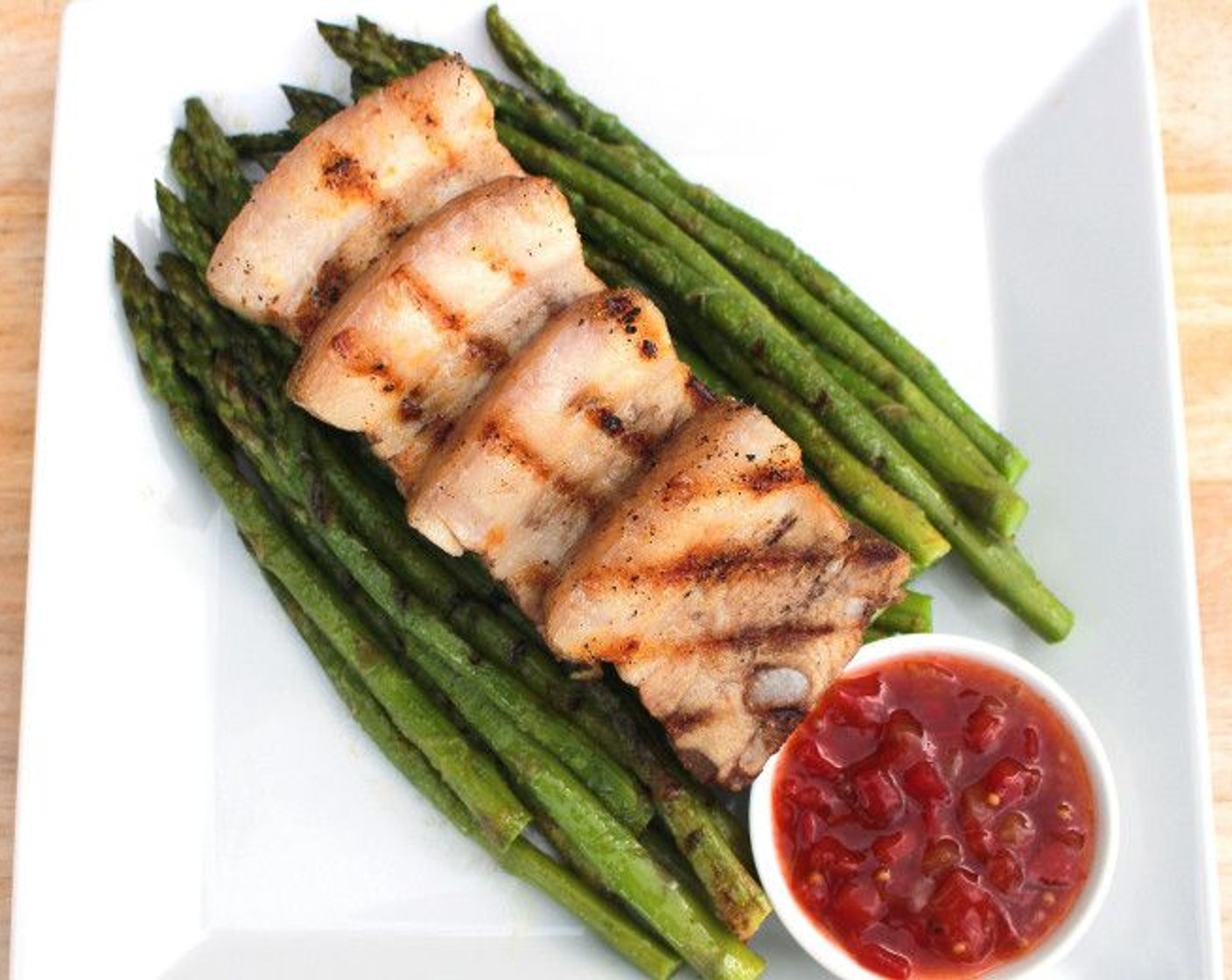 step 9 Serve the pork belly on top of the grilled asparagus.