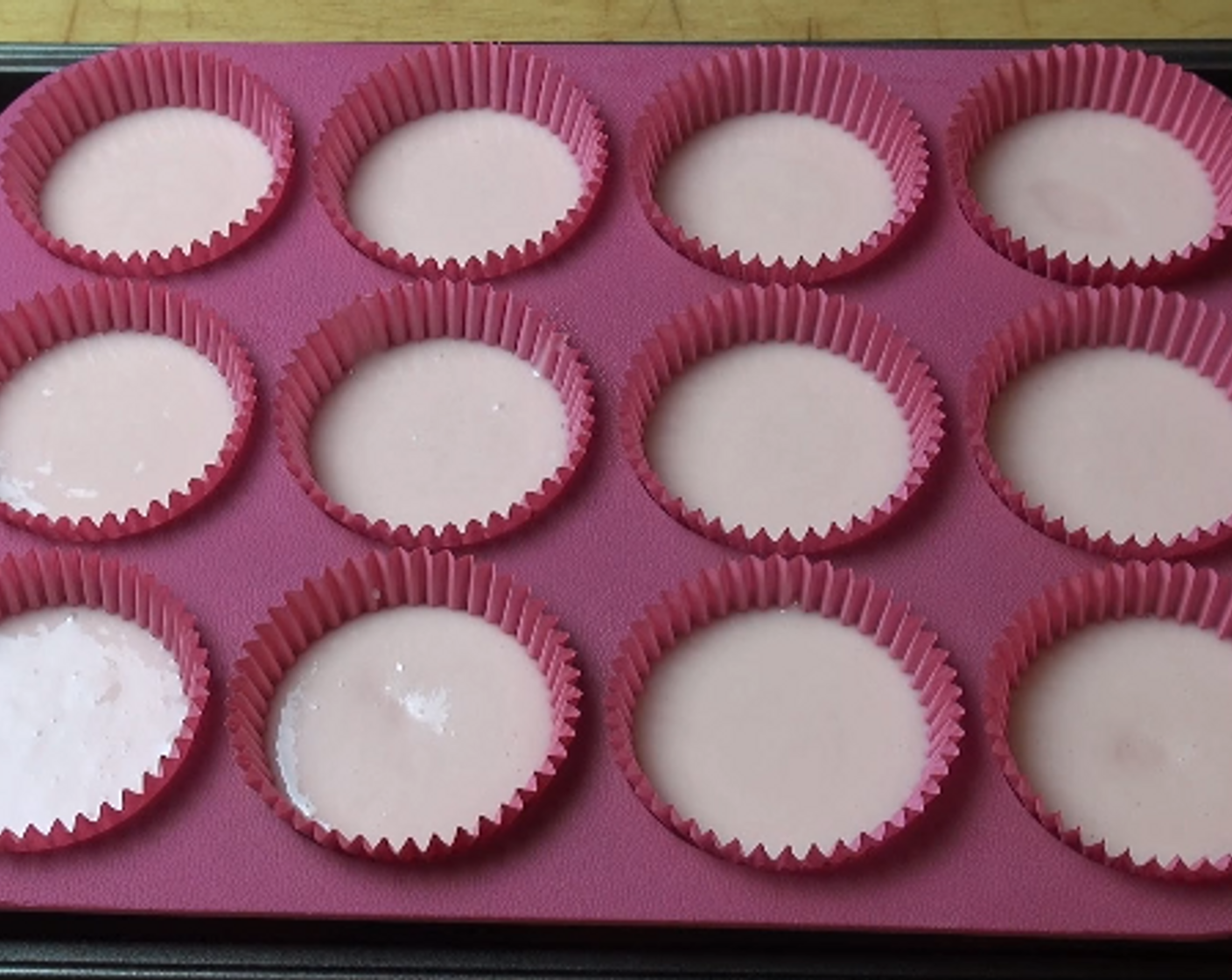 step 2 Line a 12-hole muffin pan with paper cups. Carefully spoon the cupcake mixture into each cup. Cook at 180 degrees C (350 degrees F) for 20-25 minutes or until the cakes are cooked all the way through.