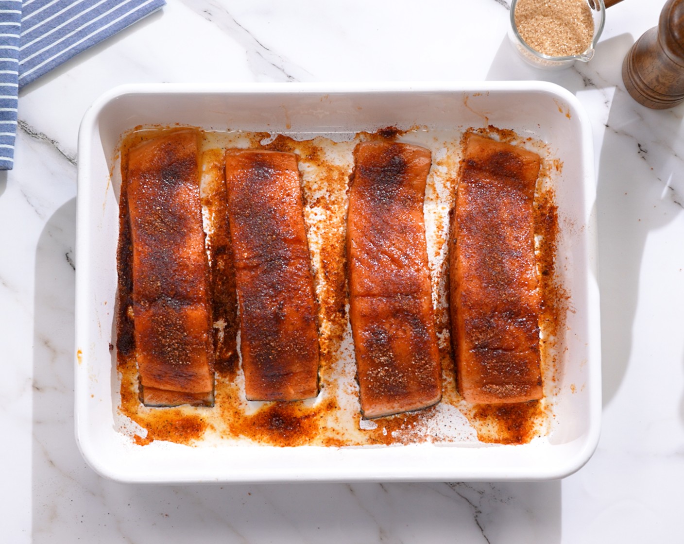 step 2 Rub each Salmon Fillets (4) with Olive Oil (2 Tbsp). Then rub with seasoning.