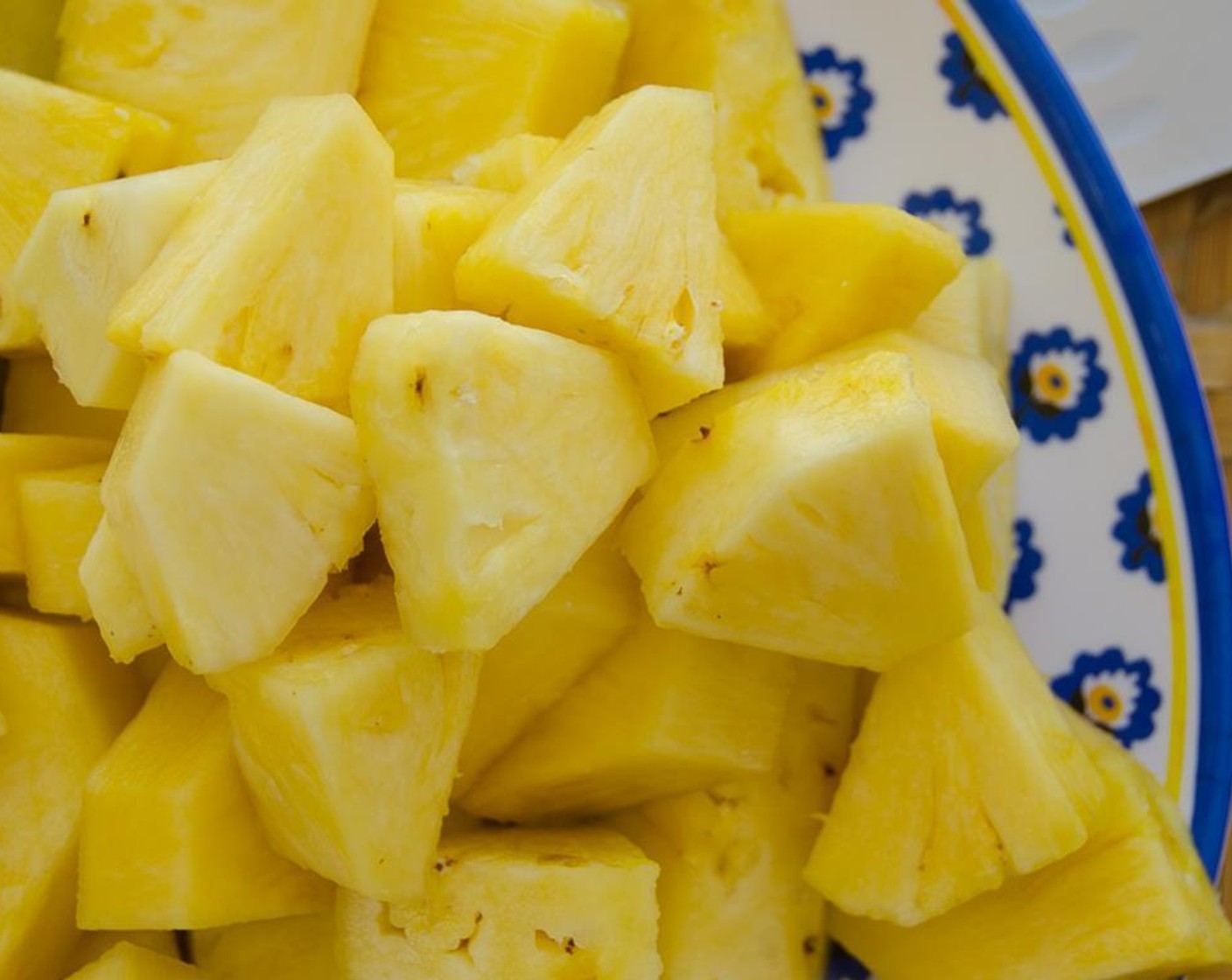 step 2 Trim the Pineapple (1) top and bottom. Cut away the prickly skin, slice the pineapple into quarters, vertically. Cut away the core and discard. Cut the pineapple flesh into chunks.