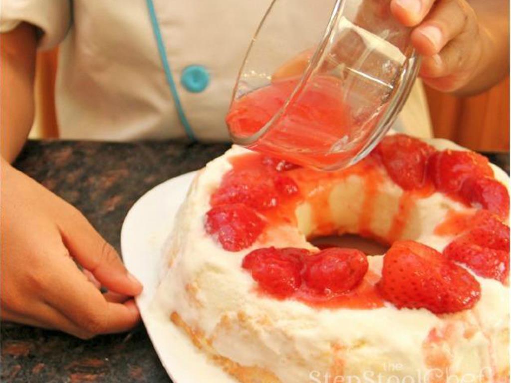 Step 5 of YaYa's No-Bake Strawberry Shortcake Recipe: Then add a layer of Frozen Strawberries (1 pint) on the bottom half of the cake. You can even pour some of the juice over the strawberries.  This part is a lot of messy fun!