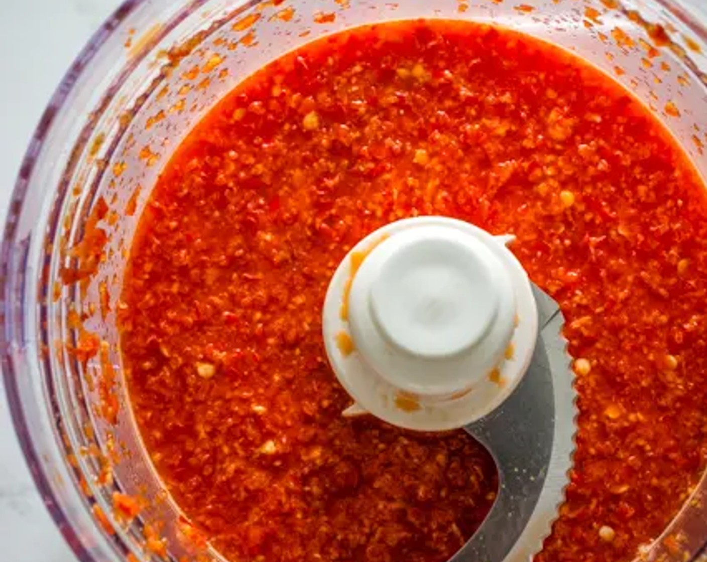 step 1 Add Red Chili Pepper (1 cup), Red Bird's Eye Chili Pepper (1), Garlic (5 cloves), Water (1/2 cup), and Rice Vinegar (1/2 cup) to a food processor. Blend to a pulp. Not too smooth, you’ll still want to see little bits of the chili.