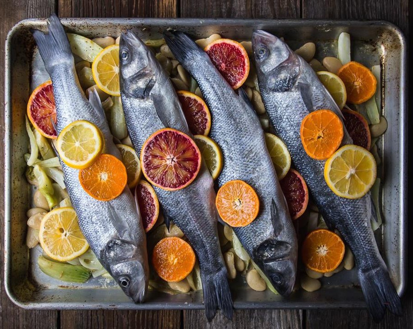 step 5 Lay each prepared fish atop the fennel and bean mixture on the baking sheet. Stuff each fish with Blood Oranges (to taste) and lay additional slices of citrus atop the fennel and bean mixture.