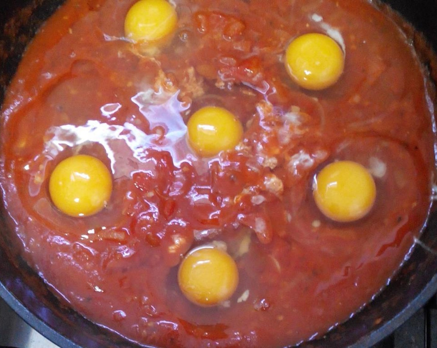 step 7 Crack the Eggs (6) over the top of the sauce. Cook without the lid and until the eggs are cooked to your liking.
