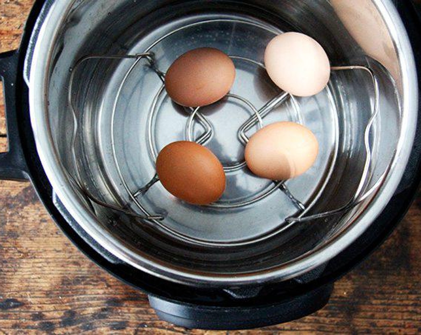 step 1 Pour Water (2 cups) into the insert of the Instant Pot. Lay the steamer insert inside. Place Eggs (4) on top.