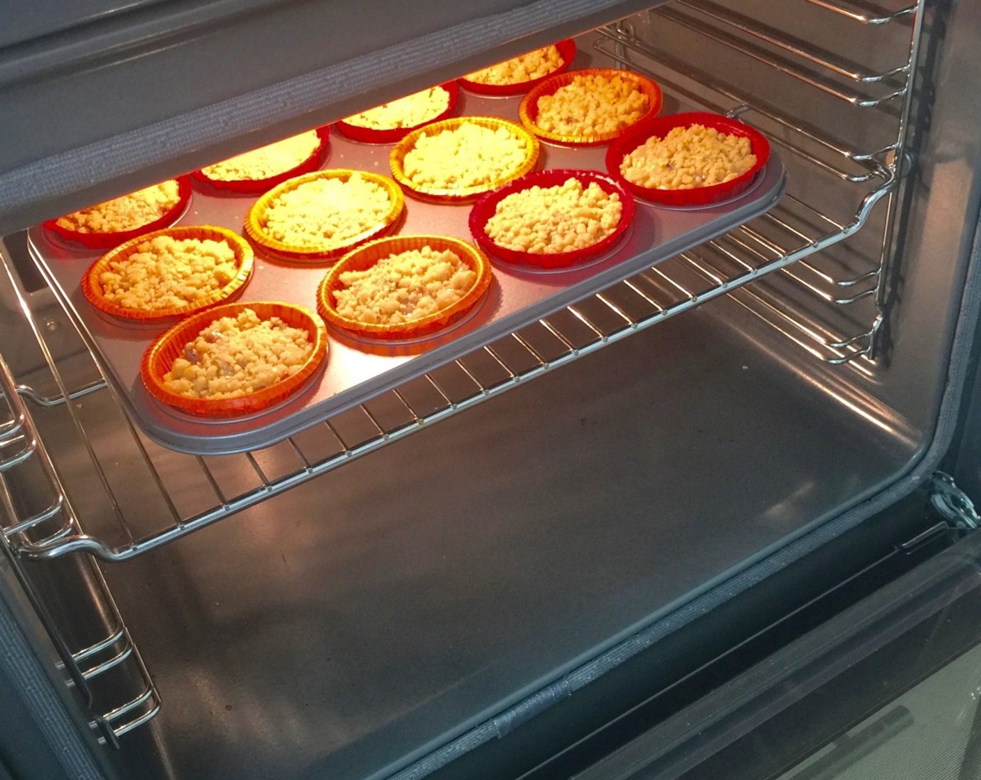 step 24 Bake the muffins in the preheated oven for about 28 minutes or until firm and a toothpick inserted into the centre of a muffin comes out clean.
