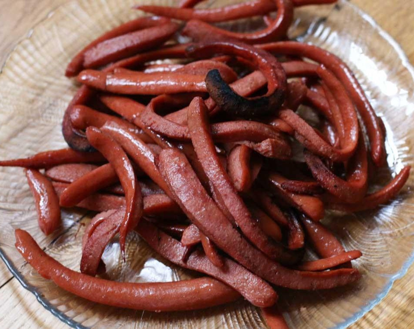 step 2 Grill hotdogs until they begin to curl.