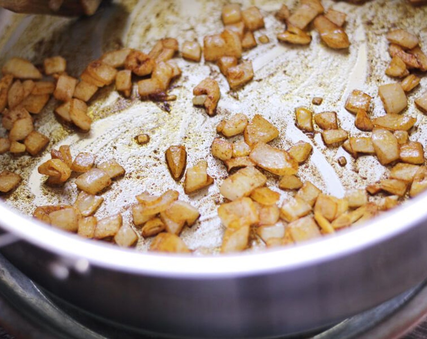 step 9 While the potatoes are baking, cook the garlic in Olive Oil (1 Tbsp) over medium-low heat. Stir constantly and cook until the garlic starts to turn golden.