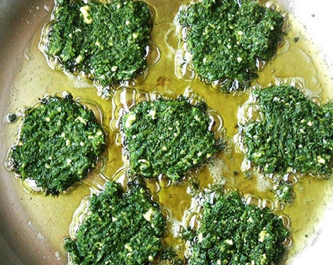 step 6 Heat 1 tablespoon of Olive Oil (as needed) in a large sauté pan over medium-high heat. When oil is hot, spoon in 1 heaping tablespoon of mixture for each fritter.