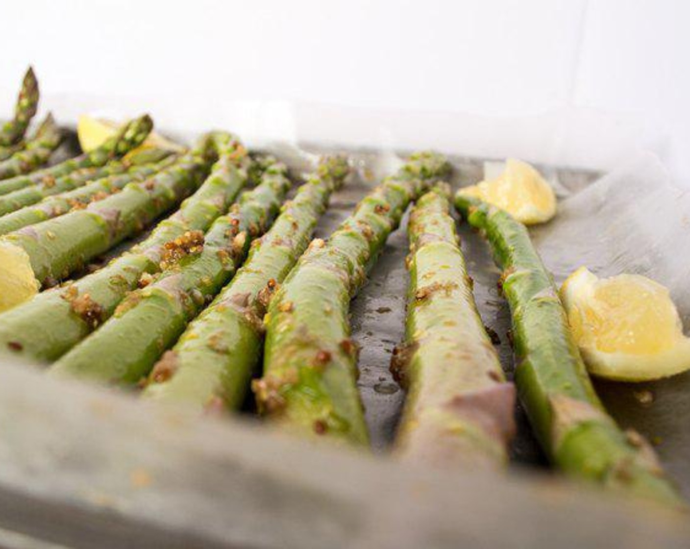 step 6 Line baking sheet with parchment paper and lay out asparagus, single layer, then top with Lemon (1).