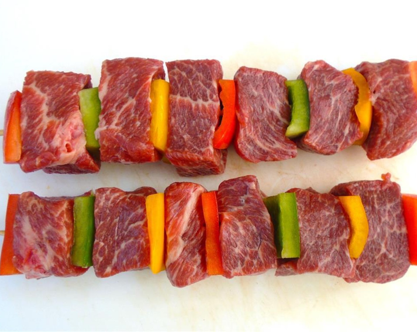 step 4 Thread the cubes of beef tenderloin and sweet peppers onto the water soaked bamboo skewers. Season with Kosher Salt (to taste) and ground Cayenne Pepper (to taste).