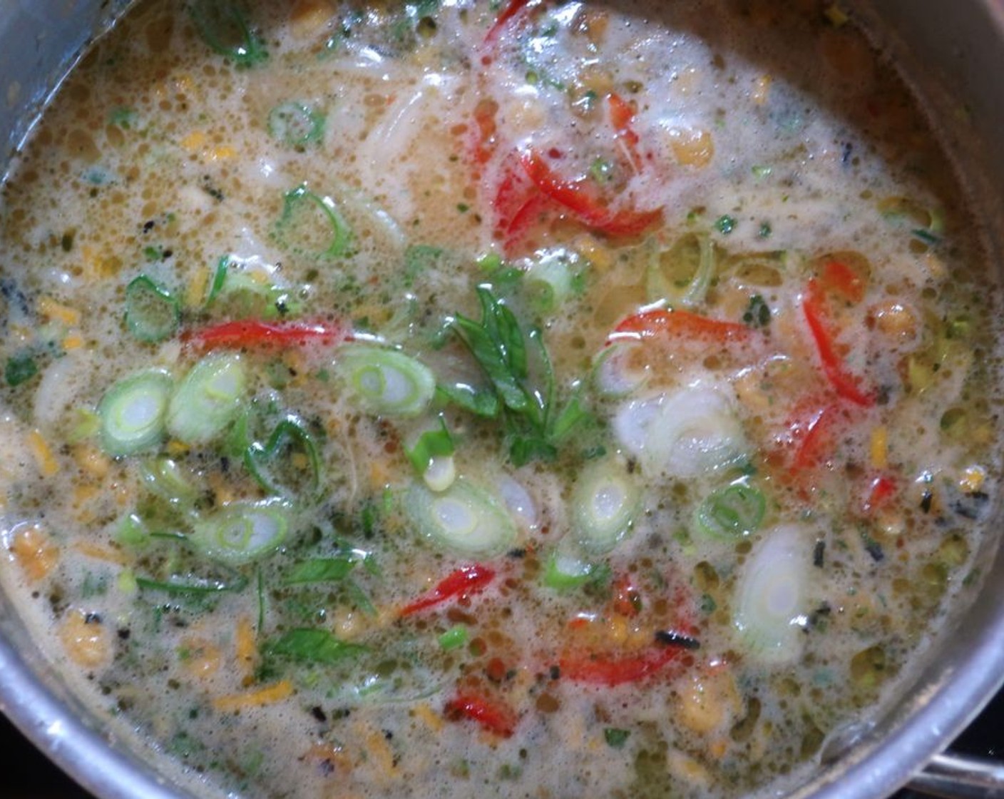 step 4 Add Udon Noodles (1 pckg) and 1/2 of the chicken to the soup, heat through and check/adjust for seasoning. Add Scallions (2 Tbsp), Fresh Cilantro (to taste) and Chili Peppers (to taste).