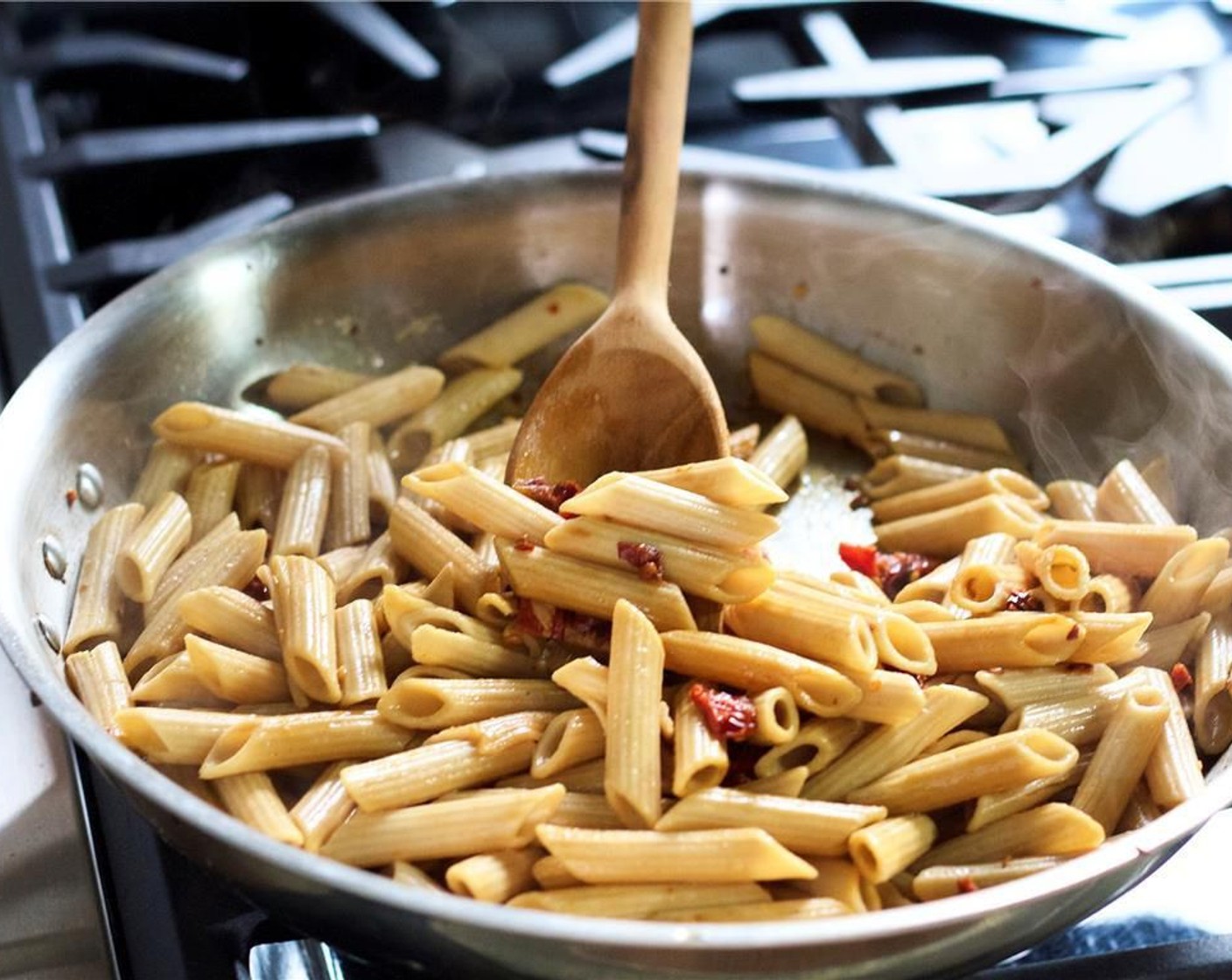 step 10 Add the penne pasta, the quarter cup of reserved pasta water, and Olive Oil (1 Tbsp). Toss to coat.