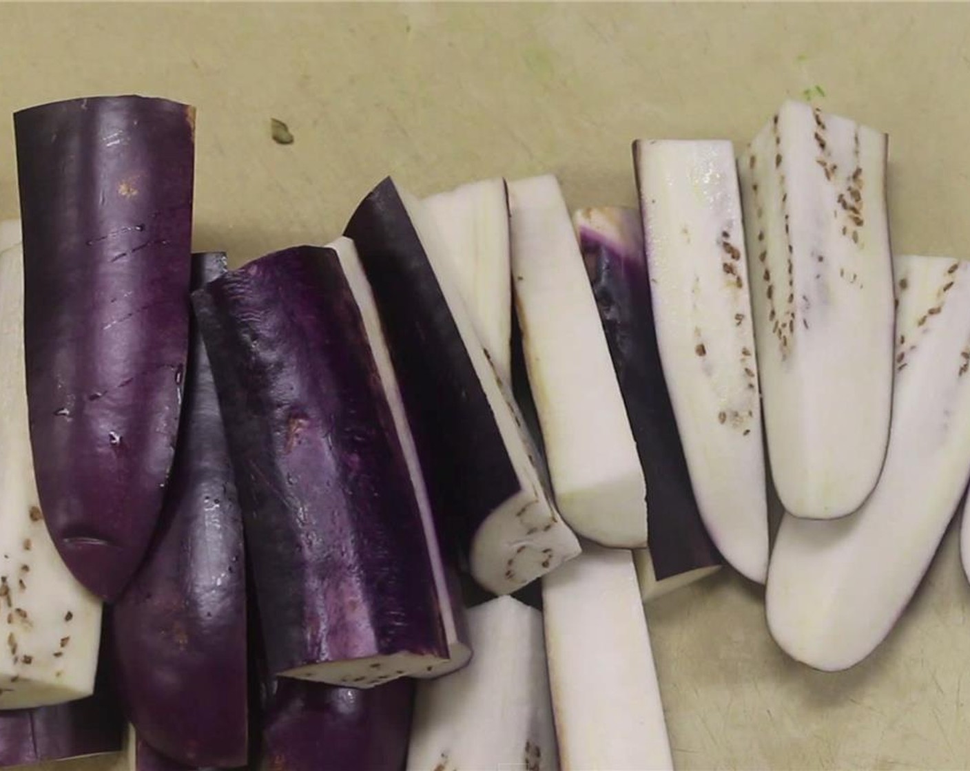 step 9 Trim off the ends of the Eggplants (2) and cut into approximately 4-5 inch portions, then cut into quarters.