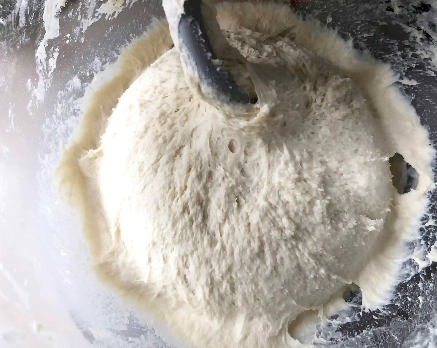 step 4 Using the dough hook, mix until the flour is completely incorporated, about 4 minutes. The dough should be very sticky. Dust lightly with flour and remove from the bowl.