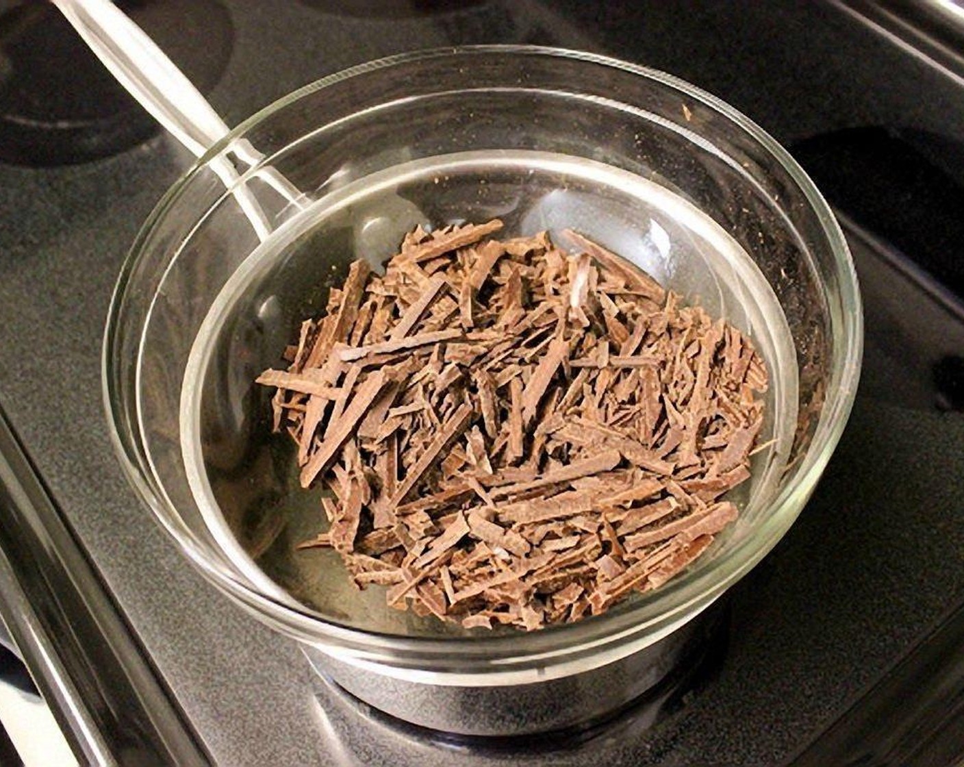 step 3 Melt the chocolate for the cake and for the frosting over a double broiler. I use a glass bowl set over a small saucepan with about an inch of water in the saucepan.